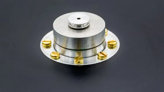 The MHCS micro heating and cooling stage — a cylindrical aluminium stage on a round flanged base ringed with brass fixing screws.