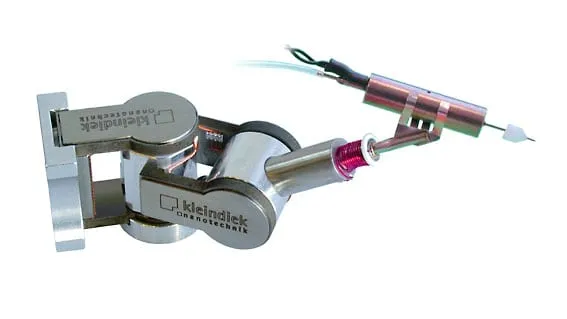 The MIS-EM microinjection plug-in on a Kleindiek MM3A-EM micromanipulator, its micro-valve fed by inlet tubing and ending in a fine glass injection pipette.