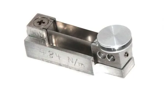 A single SpringTable with its spring constant of 484 N/m hand-engraved into the aluminium body, next to the clamped copper spring strip.